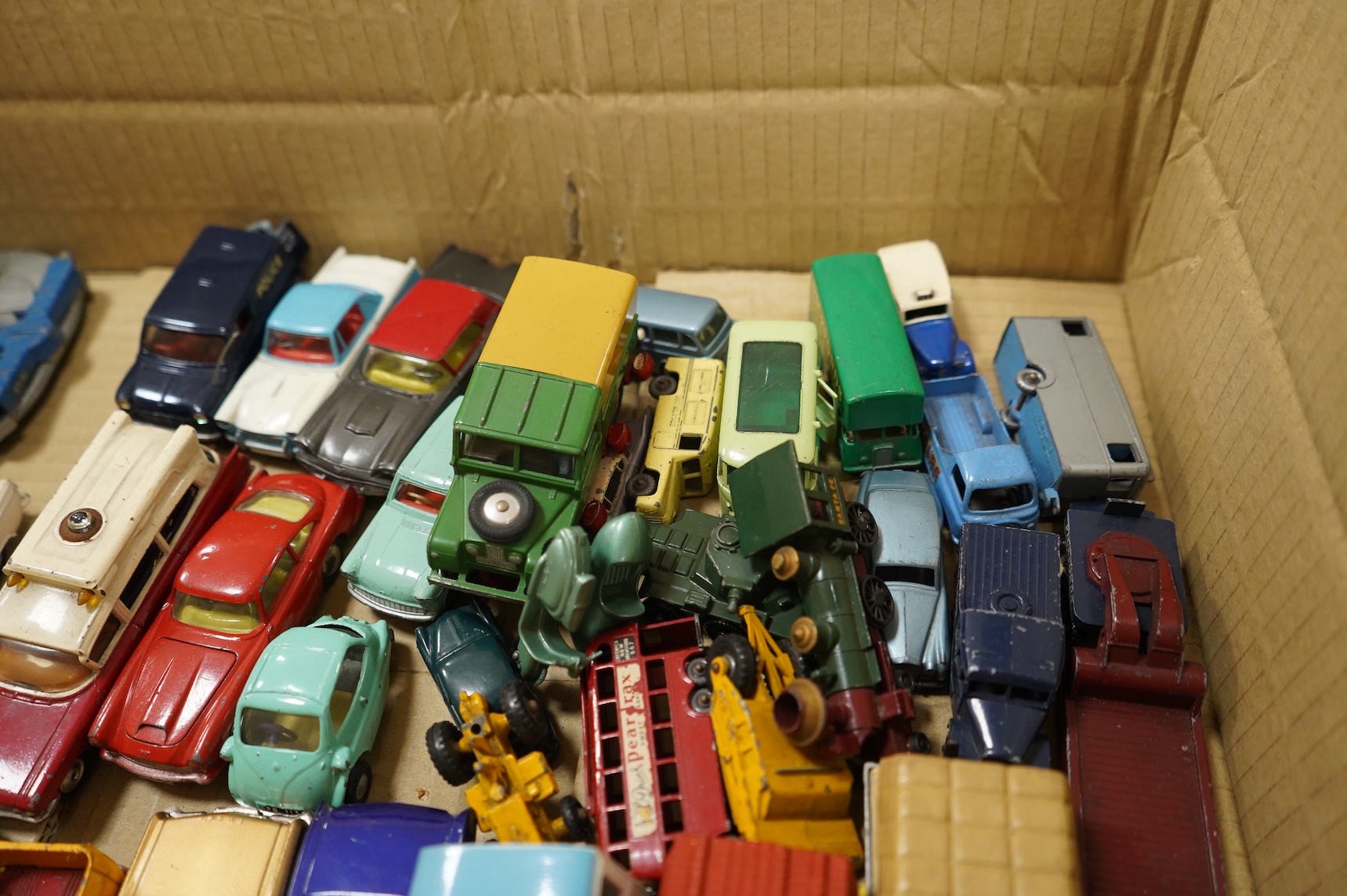 A collection of forty Corgi Toys and fourteen Matchbox Series diecast vehicles, including; The Man From Uncle Oldsmobile, a James Bond Aston Martin DB5 in gold, a Commer 5-ton truck with trailer and a selection of loads,